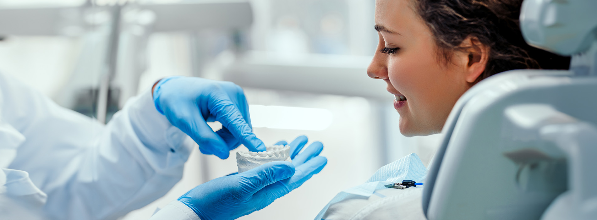 A woman receiving medical attention with a masked healthcare professional assisting.
