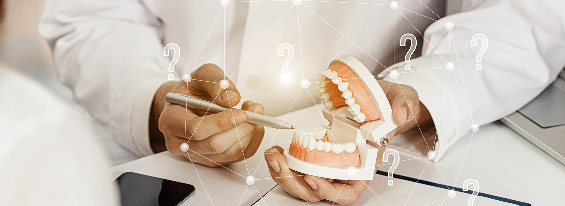 The image shows a person holding a toothbrush with their hands, while another pair of hands holds a toothpaste tube.