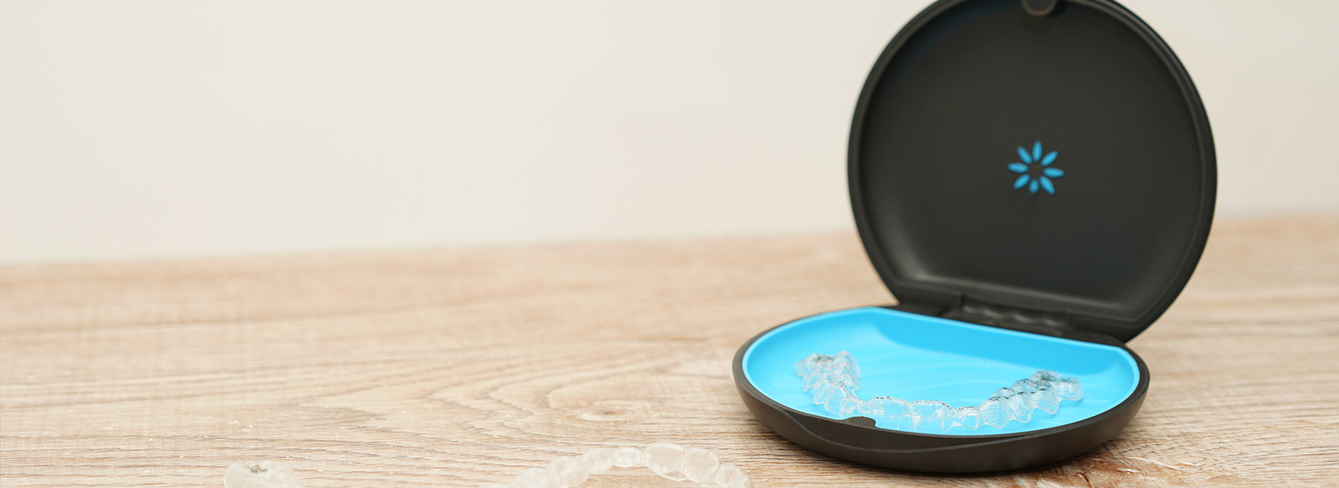 A small blue object with a black lid on a white surface.