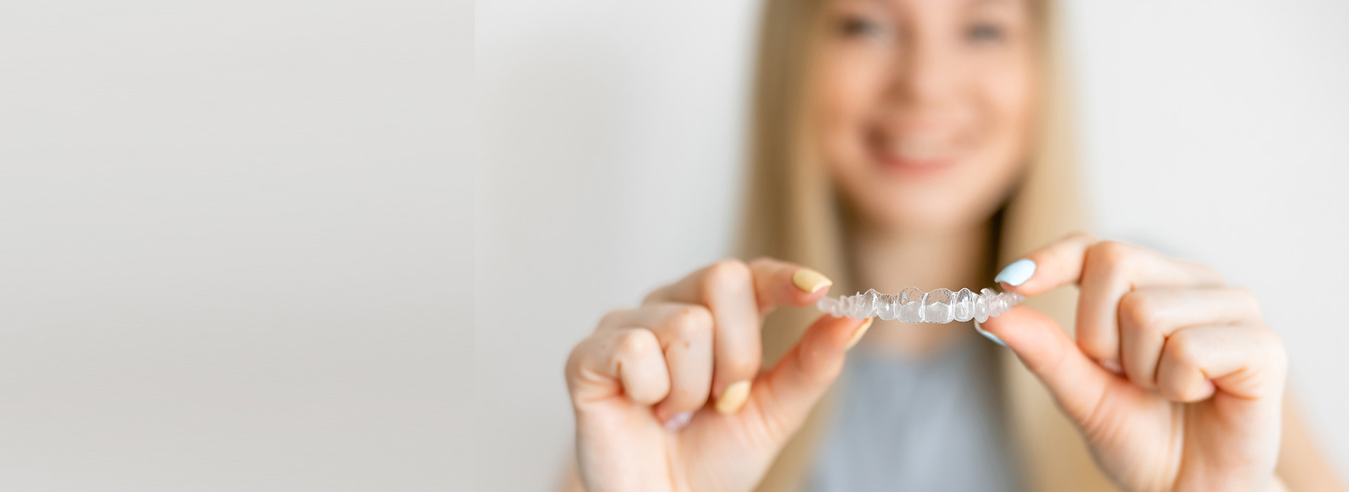 The image shows a person s hand holding an object with text, which appears to be a product or a sample, against a white background.